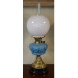 Victorian oil lamp, the blue glass reservoir having foliate decoration in relief, embossed brass