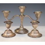 Edward VII silver three branch candelabra together with a pair of similar desk candlesticks, all