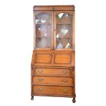 1920's period oak bureau bookcase, the upper section fitted three shelves enclosed by a pair of