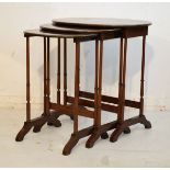 Nest of three reproduction brass inlaid mahogany coffee tables on turned supports Condition: