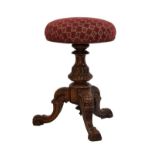 Victorian carved walnut revolving piano stool standing on a turned pillar and tripod base Condition: