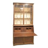 Mahogany finish bureau bookcase, the upper section fitted three shelves enclosed by a pair of