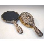 Edward VII embossed silver backed hand mirror, Birmingham 1908 together with a matching hair brush