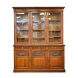 Edwardian walnut library bookcase, the upper section fitted eight shelves enclosed by three glazed