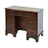 Reproduction mahogany finish pedestal desk fitted eight drawers and having an inset leather