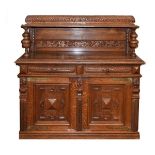 Late 19th/early 20th Century carved oak buffet, the raised back having an open shelf supported by