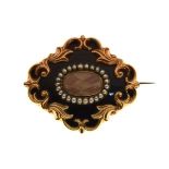 Victorian gold coloured metal mourning brooch having woven hair panel within a seed pearl border and