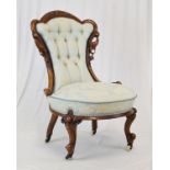 Victorian walnut framed salon chair having carved cresting, raised on cabriole supports fitted