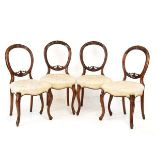 Set of four Victorian rosewood balloon back dining chairs having buttoned seats and cabriole front