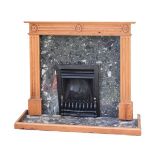 20th Century fireplace having marble hearth surround and with metal inset with fluted pine