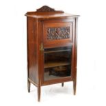 Late 19th/early 20th Century walnut music cabinet fitted three shelves, the door with carved panel