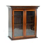 Late 19th/early 20th Century walnut bookcase fitted two shelves enclosed by a pair of glazed doors
