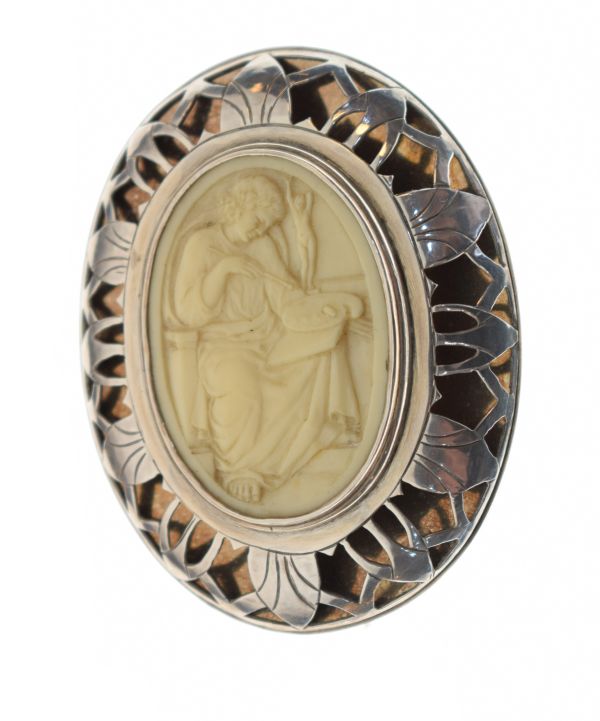 Large oval silver brooch set faux ivory panel depicting an artist at work within a pierced surround,