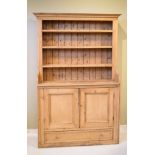 Late 19th/early 20th Century stripped pine dresser, the upper section fitted four open shelves,