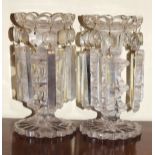 Pair of 19th Century clear cut glass lustre drop candlesticks, each standing on a star cut foot