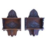 Pair of carved mahogany and hardwood wall brackets, each having foliate decoration and fitted two