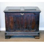 Antique oak blanket box having a fielded panelled top, blind panel front and sides and standing on