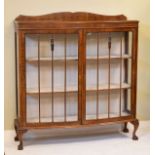 1930's period walnut bowfront display cabinet fitted three shelves and standing on cabriole ball and