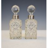 Pair of Victorian cut glass scent bottles, the silver collars hallmarked for Birmingham 1897