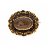 Victorian yellow metal and enamel mourning brooch having a central hair panel Condition: