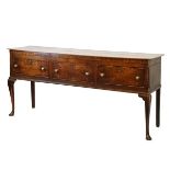 George III oak low dresser, fitted three drawers and standing on cabriole supports, 179cm wide