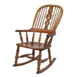 19th Century oak ash and elm high back Windsor rocking chair having a hard seat standing on turned