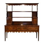 George III mahogany crossbanded oak high dresser, the plate rack with moulded cornice, open
