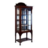 Edwardian carved mahogany display cabinet, the raised back with carved ribbon and swag decoration,