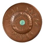 Arts & Crafts copper charger having embossed leaf decoration emanating from a deep well with a