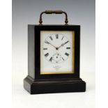 Late 19th/early 20th Century French ebonised cased carriage clock having a brass folding handle to