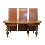 Victorian mahogany oval extending dining table fitted four insertions and standing on six tapered