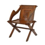 Early 20th Century carved oak Glastonbury chair bearing the script 'What so ever thy hand findeth to