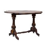 Victorian figured walnut shaped top centre table having a carved edge and standing on twin turned