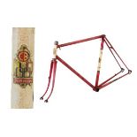 Claude Butler steel racing cycle frame in metallic red with white head tube and gold decals,