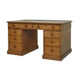 Late 19th/early 20th Century oak double pedestal kneehole desk, fitted eight drawers with turned