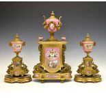 19th Century French ormolu and porcelain garniture de cheminee, the clock case surmounted with a