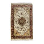 Good quality modern Persian silk rug decorated with a central medallion on a tight-knit floral