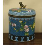 Chinese cloisonné cylindrical jar and cover having a Fo Dog finial, allover floral decoration on a