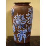 Stoneware art pottery vase having blue stylised foliate decoration in low relief on a textured brown