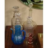 Three cut glass decanters, a blue Soda glass ewer and a small cranberry glass vase Condition: