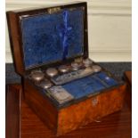 Victorian figured walnut travelling toiletry box, the hinged cover opening to reveal a fitted