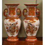 Pair of Japanese Kutani porcelain two handled baluster shaped vases, each decorated with figures