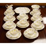 Cauldon ten person tea service having stylised foliate decoration in lilac and yellow Condition: