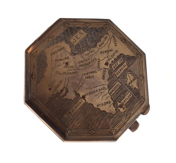 White metal octagonal compact engraved with a map of India inset with ruby coloured stones, the