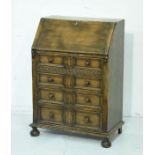 Good quality reproduction distressed oak bureau, the fall flap opening to reveal a fitted