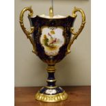 Large late 19th Century Coalport porcelain three handled goblet having reserves decorated with