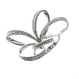 Diamond set dress ring of five looped ribbon design, the white metal shank stamped 750, size N