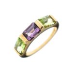 9ct gold dress ring set central rectangular amethyst coloured stone flanked each side by pale