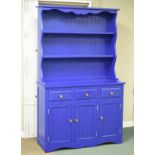 Modern blue painted dresser fitted three drawers over two panelled doors with plate rack over