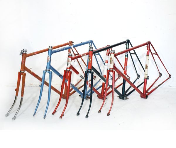 Vintage racing cycle frames comprising: Two Claude Butler frames in green and metallic red